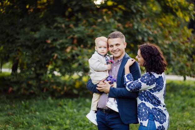 Outdoor portrait of a happy family enjoying the fall season