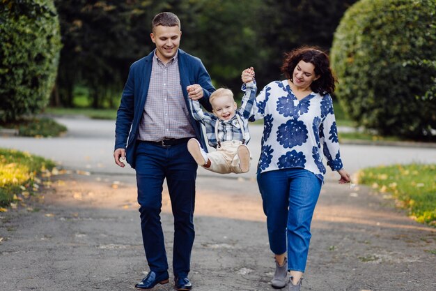 Outdoor portrait of a happy family enjoying the fall season