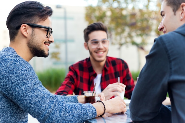 Free photo outdoor portrait of young entrepreneurs working at coffee bar.