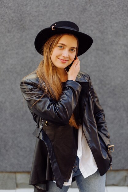 Outdoor summer portrait of young stylish girl posed in sunny day on street