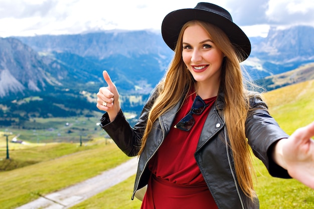 Outdoor traveling portrait of pretty cheerful young tourist woman 