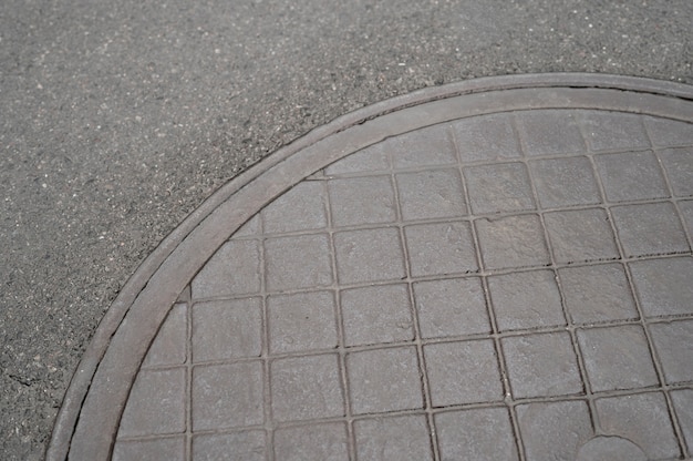 Free photo outdoors cobblestone texture with manhole