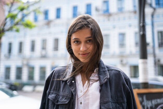 Outdoors street portrait of beautiful young brunette woman