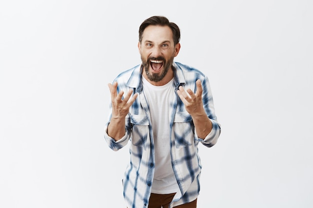 Outraged bearded mature man posing