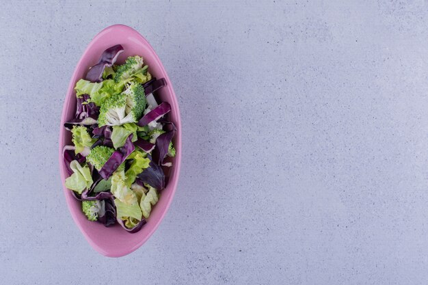 Oval salad bowl on marble background. High quality photo