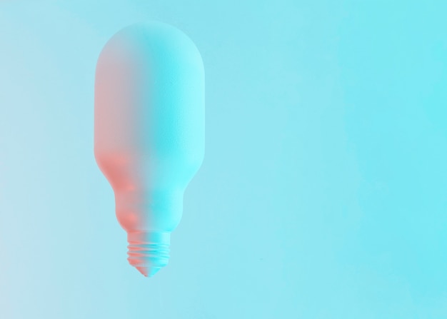 Oval white shape painted light bulb against blue background
