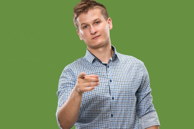 The overbearing businessman point you and want you, half length closeup portrait on green background.