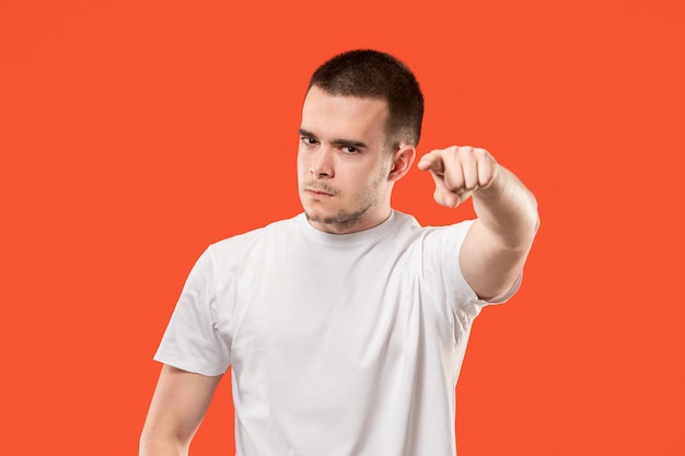 Overbearing businessman point you, want you, half length closeup portrait on orange studio background.