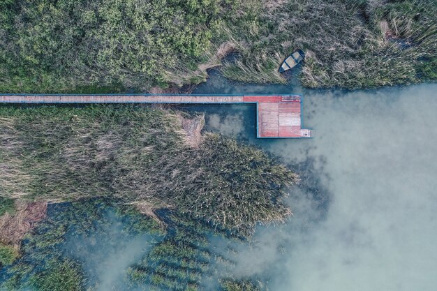 Overhead aerial shot of a small fishing spot near a lake