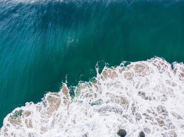 Overhead aerial shot of a wavy blue sea - perfect for