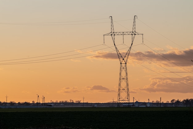 Overhead power line in the countryside at sunset
