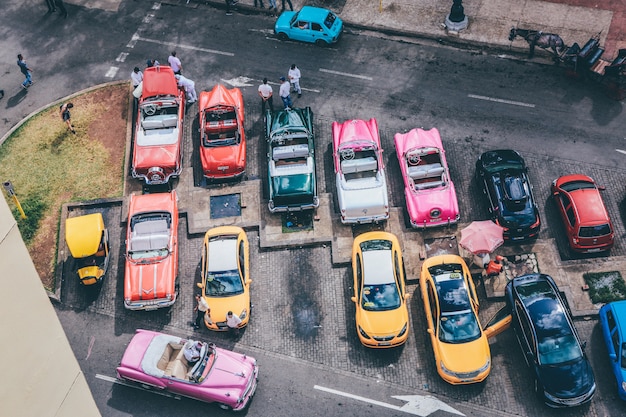 駐車場でさまざまな色の各種車のオーバーヘッドショット