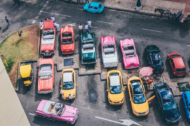 Overhead shot of assorted cars in different colors in a parking lot