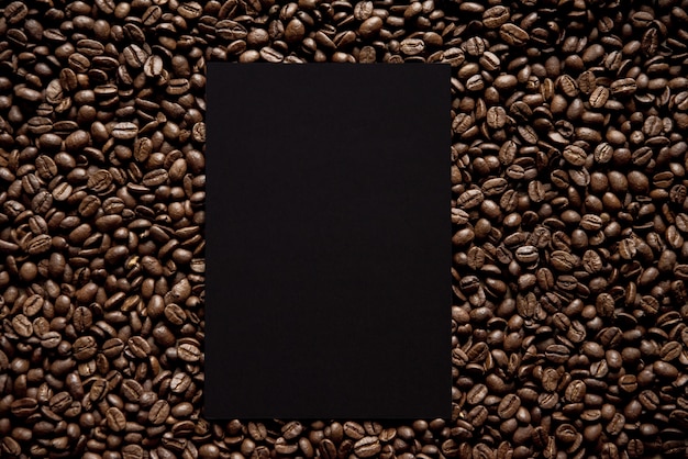Overhead shot of a black square in the middle of coffee beans great for writing text