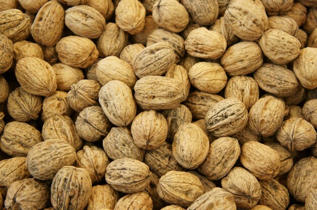 Overhead shot of a bunch of walnuts stacked on each other