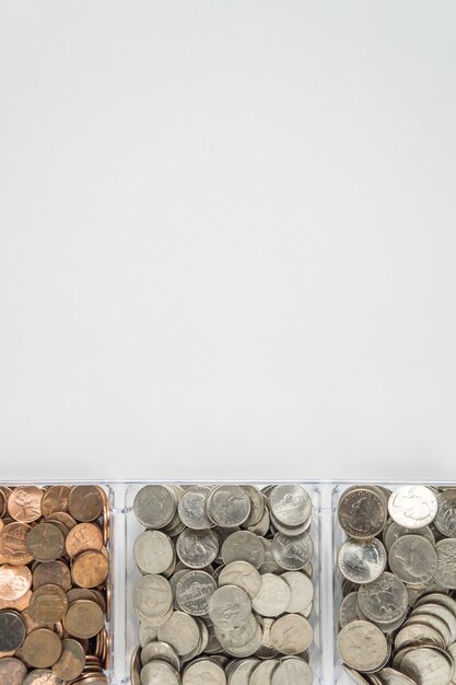 Overhead shot of cents in containers isolated on a grey wall