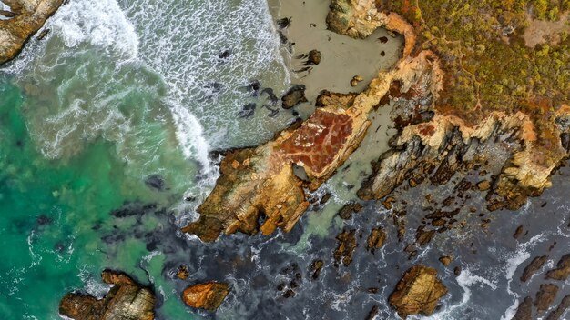 Overhead shot of coral reefs at the coast of the sea with amazing water textures and waves