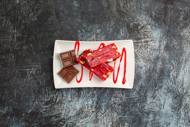 Overhead shot of delicious chocolates on white plate on grey ground