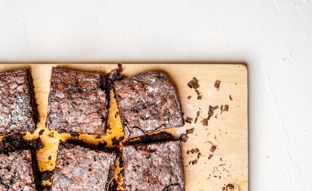 Overhead shot of freshly baked brownies on a wooden board