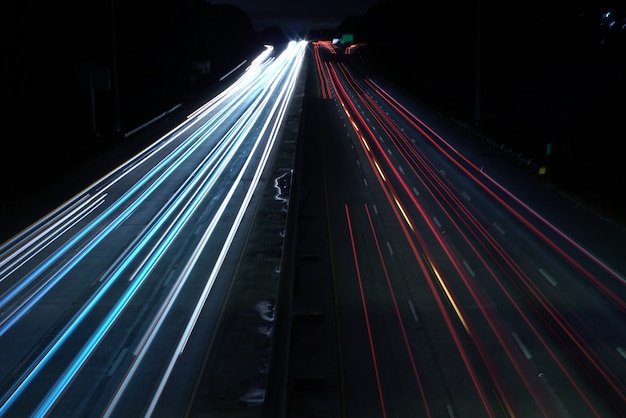 Overhead shot of a highway road with car light speed trails