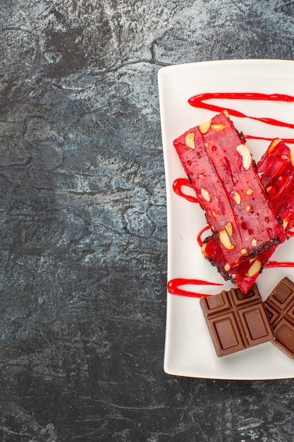 Overhead shot of a plate of chocolate bars on the right side of grey