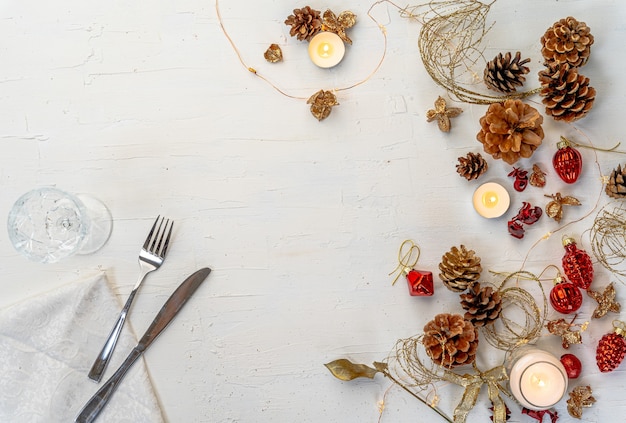 Overhead shot of a rustic colorful Christmas dining table with decors and space for text