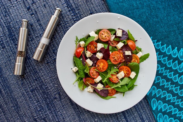 Overhead shot of a vegan salad on a round white ceramic plate