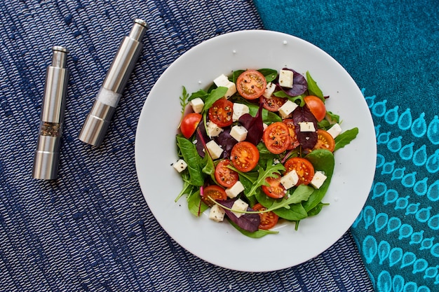 Overhead shot of a vegan salad on a round white ceramic plate