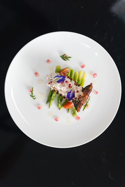 Overhead vertical shot of a dish with vegetables on a white plate