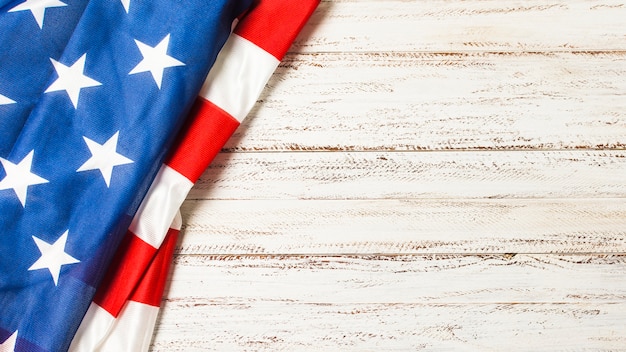 An overhead view of american flag for memorial day on white desk