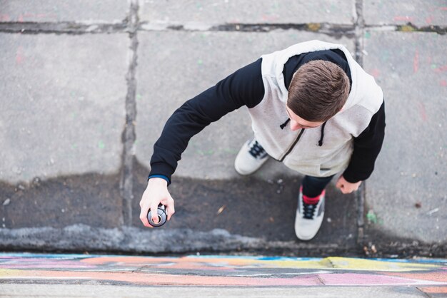 Overhead view of a artist while drawing graffiti