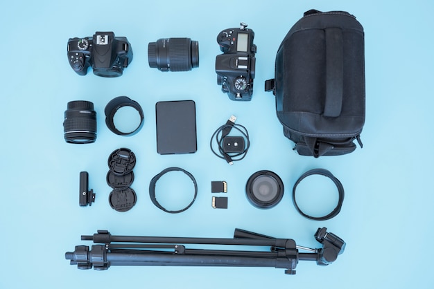 Overhead view of bag and appliances for photography over blue background