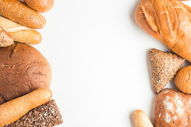 Overhead view of baked bread loves on white background