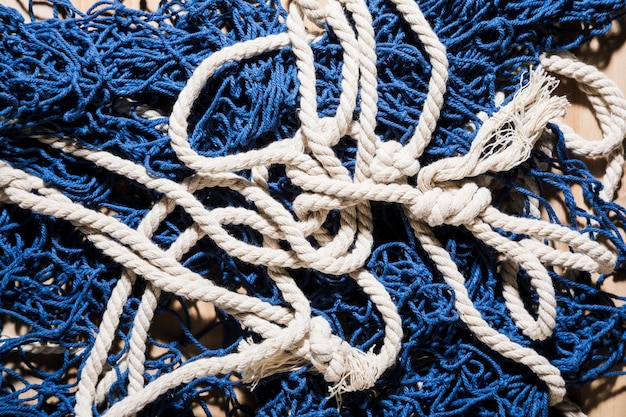 An overhead view of blue fishing net with white rope
