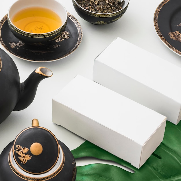 Overhead view of boxes and herbal tea on white background