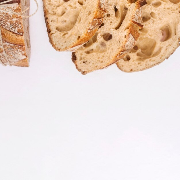 An overhead view of bread slice on white background