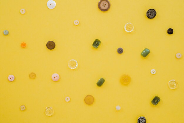 An overhead view of buttons on yellow backdrop