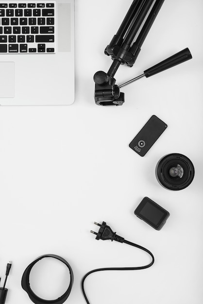 An overhead view of camera accessory with laptop on white background