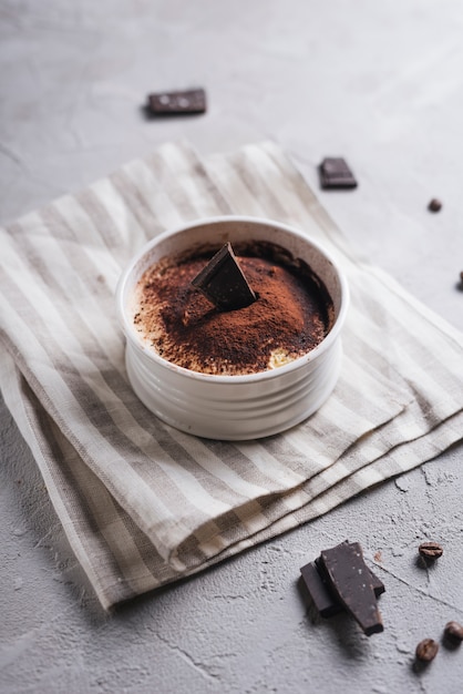 An overhead view of chocolate moose dessert in ceramic white bowl over the napkin