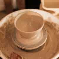 Free photo an overhead view of clay bowl on pottery wheel