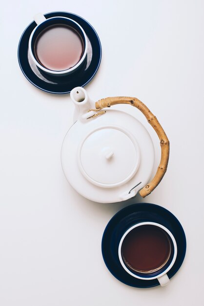 Вид сверху кофейной чашки и чайника, изолированных на белом фоне