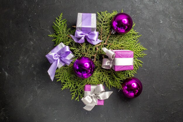 Overhead view of colorful gifts and decoration accessories on dark background