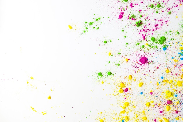 An overhead view of colorful holi power on white background