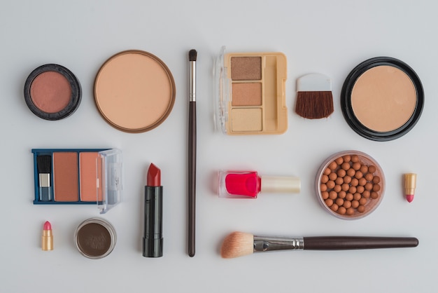 An overhead view of cosmetic beauty products on white background