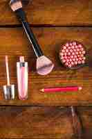 Free photo overhead view of cosmetic products on wooden background