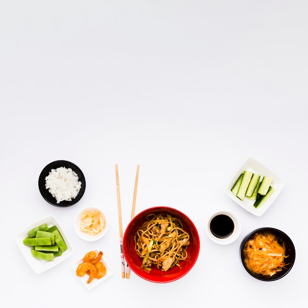 An overhead view of delicious asian food isolated on white surface