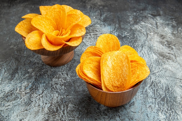 Overhead view of delicious homemade potato chips on gray table