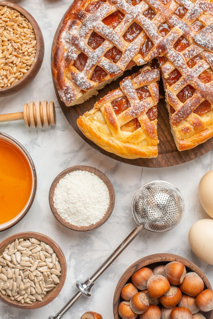 Free Photo overhead view of delicious jam pie on a wooden cutting board hazelnuts honey eggs on ice table