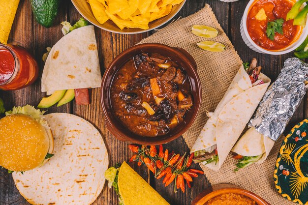 Overhead view of delicious mexican food on brown wooden table