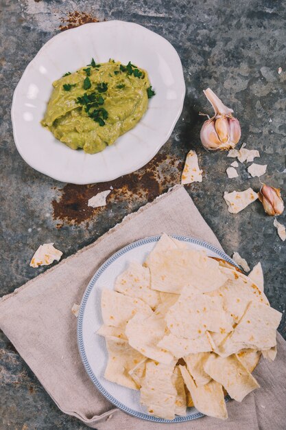 Overhead view of delicious mexican tortilla with guacamole over rusty weathered background